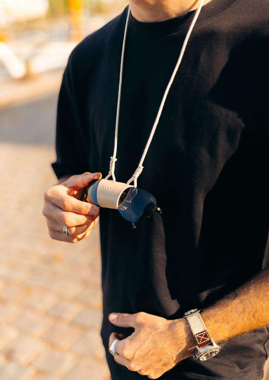 Beige solglasögonhållare i mjukt material med justerbar rund halsrem, modern stil.